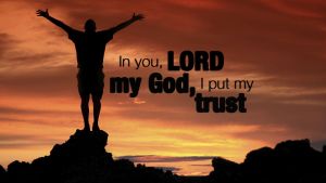The text "In You, Lord my Go, I put my trust" over a glorious sunrise with the silhoutte of the  back of a person with their arms raised to heaven.