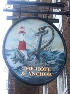 A "Hope and Anchor" pub sign, consisting of a lighthouse and an anchor with a rough sea behind.