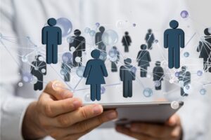 Our BCF Online Fellowship Group depicted by a pair of hands holding a tablet computer, with icons of people above the screen, connected by representations of electronic lines.