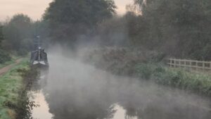 Hope in the darkness - a canal on a misty morning.